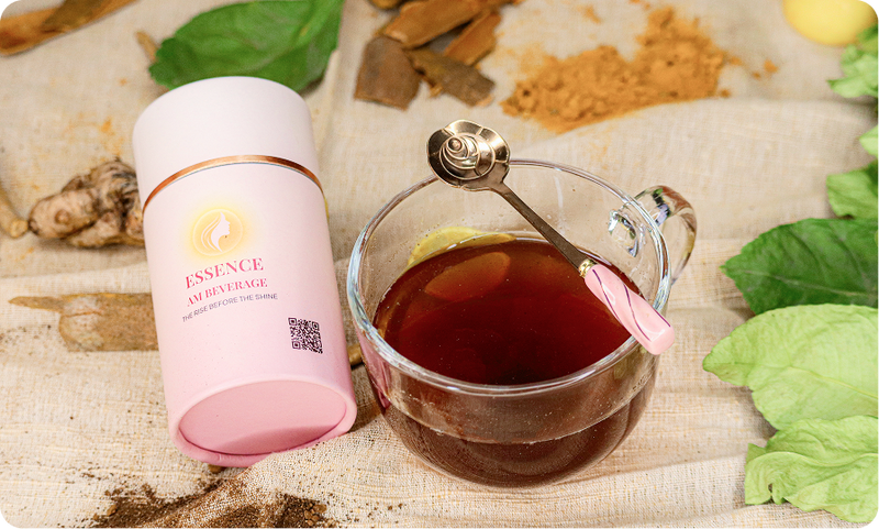 SHEIQ Essence AM Beverage beside a cup of tea with spices